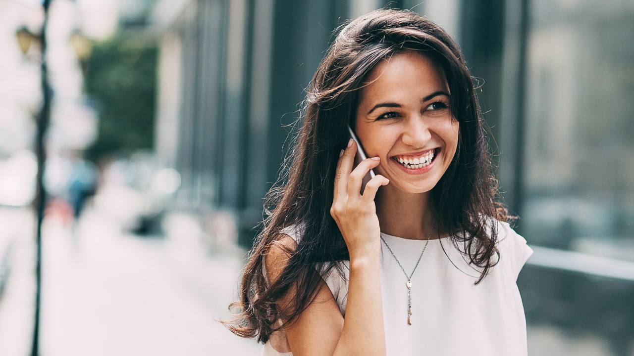 a girl using mobile phone happily; image used for HSBC MU contact us page 